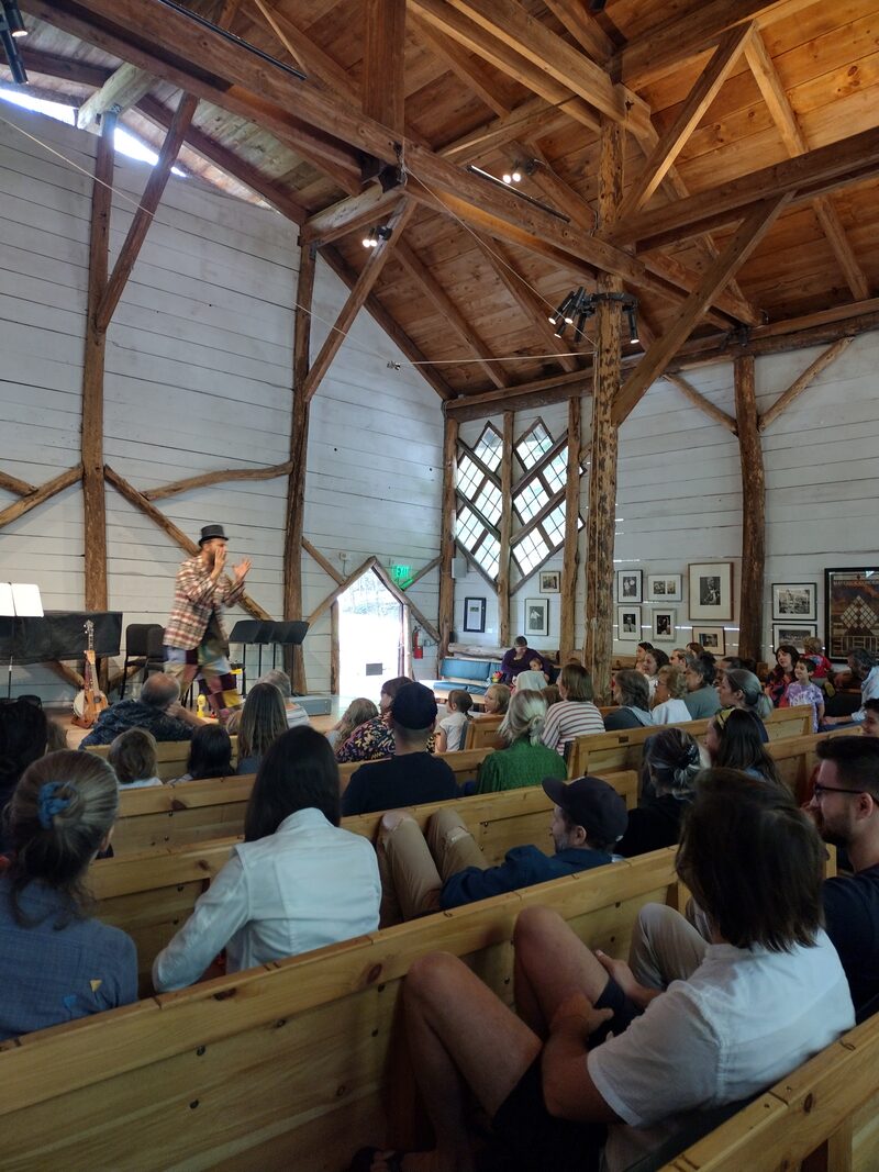 Wide shot of Maverick concert barn with audience watching Jason perform