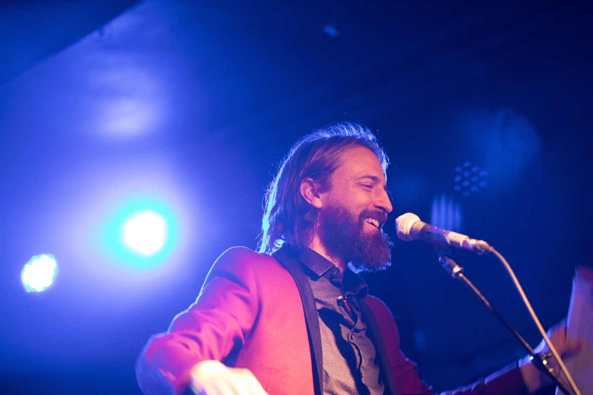 Jason on stage at BMF under blue stage lights